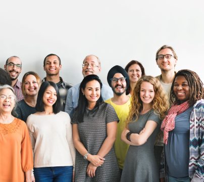 Diverse group of people standing next to each other