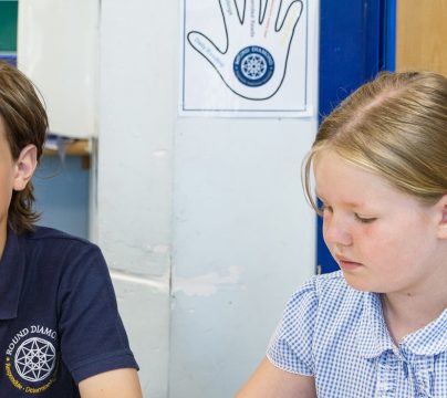 girl and boy sitting together at a desk