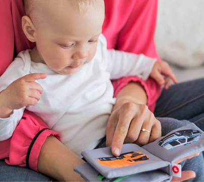 woman holding a baby with activity