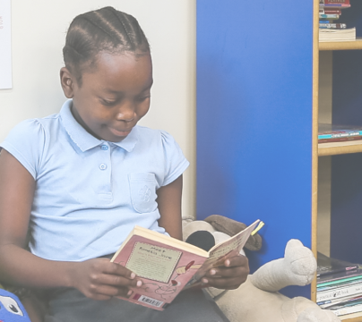 Girl in blue uniform, reading