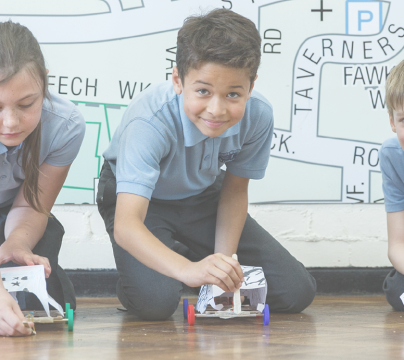 Students playing with model cars