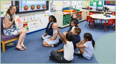 teacher with a group of children in classroom