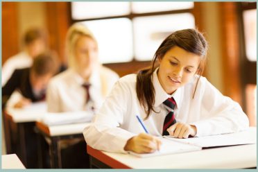 2 girls writing at desk