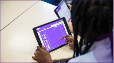 girl of colour looking at ipad