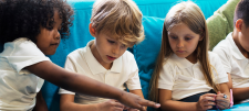 4 primary school children sitting together