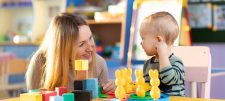 Woman with young child playing with toys