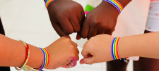 Fist bumps with rainbow wrist straps