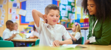 woman with boy in classroom