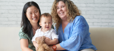 Two women holding a baby