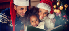 Family enjoying Christmas book