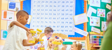 Pupils in class playing with hour glasses