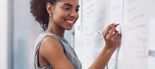 Person writing on whiteboard