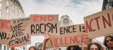 "End racism" placards at a rally