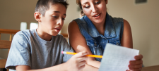 Parent and child looking at school work