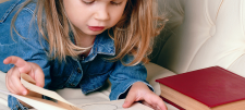 Reading at Key Stage 1 – What might we do and how might we do it? Young girl reading a book