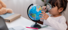 Girl looking at globe