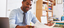 Smartly dressed teacher reading paperwork