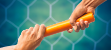 Orange baton being handed over