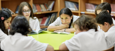 School chrildren reading in a circle 