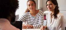 2 women, one with a stripey jumper on
