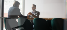 man sitting across the table from another person