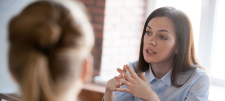 Woman sitting opposite another female