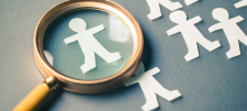 figures and magnifying glass