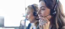 woman on a helkp desk on the phone