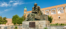 Statue in front of building and blue sky
