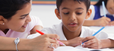 Teacher and child, writing together