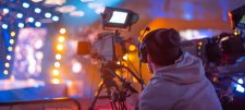 man using a camera to film something
