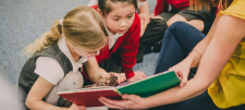 SEND World Book Day Children looking at book together