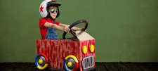 Boy riding in a small play-car