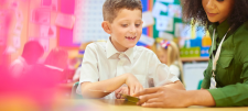Adult in green shirt with younger school child