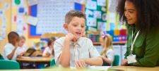 Educator with child in classroom