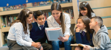 teacher and group of pupils reading