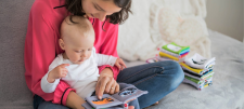 woman holding a baby with activity