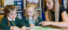female teacher with 2 early years children
