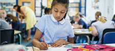 School girl writing in book