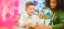 Woman in green shirt helping a school pupil
