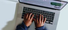 Child hands typing on laptop