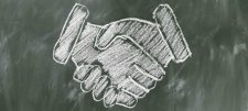 Blackboard drawing of shaking hands 