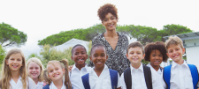 Teacher and pupils smiling for camera