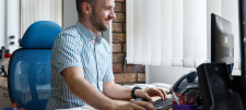 Man typing happily on keyboard