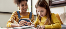 woman teaching child at home
