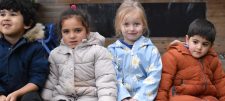 children in anoraks sitting