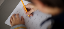 Erasing maths equation with a yellow rubber tipped pencil