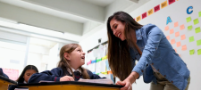 An introduction to ESSENTIALSPELLING Education leader with child over desk, both look happy
