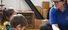 Children sitting on floor listening to practitioner
