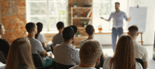 What school governors need to know about Early Years Adult talking to a room of seated adults